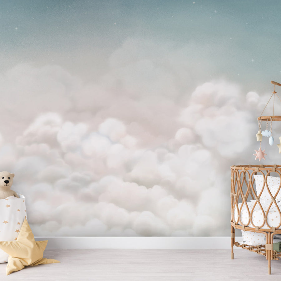 Calming Clouds – Blue wallpaper mural shown in a children's nursery crib
