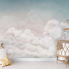 Calming Clouds – Blue wallpaper mural shown in a children's nursery crib