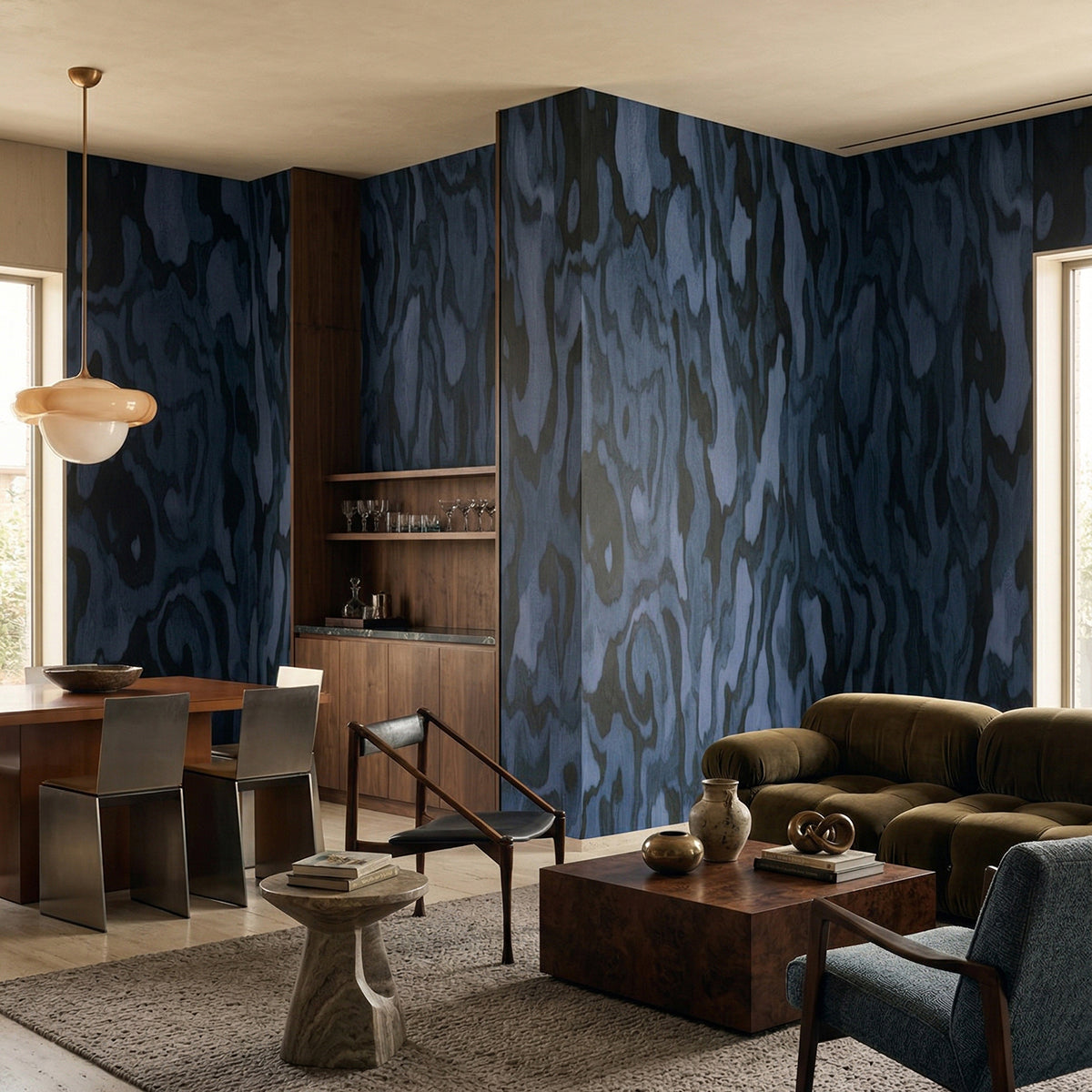 Ettore Burl wallpaper mural shown in living room with green sofa and open plan