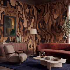 Ettore Grain wallpaper mural shown in living room with rust sofa and grey chair