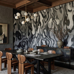 Ettore Line wallpaper mural shown in dining room with table and wood chairs