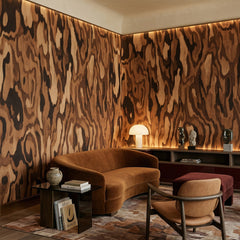 Ettore Walnut wallpaper mural shown in living room with brown sofa and wood chair