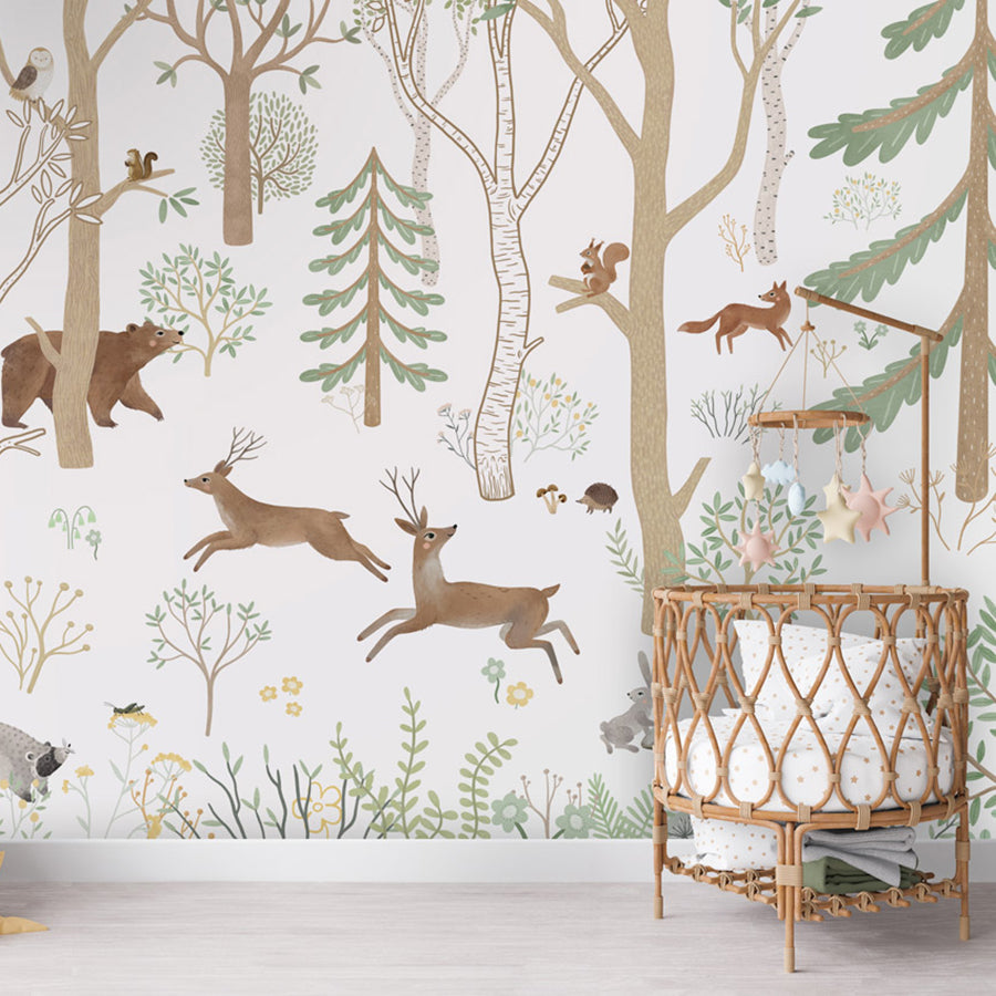 Frisky Forest – Green wallpaper mural shown in a children's nursery crib