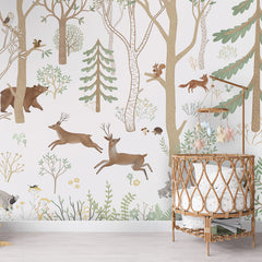 Frisky Forest – Green wallpaper mural shown in a children's nursery crib