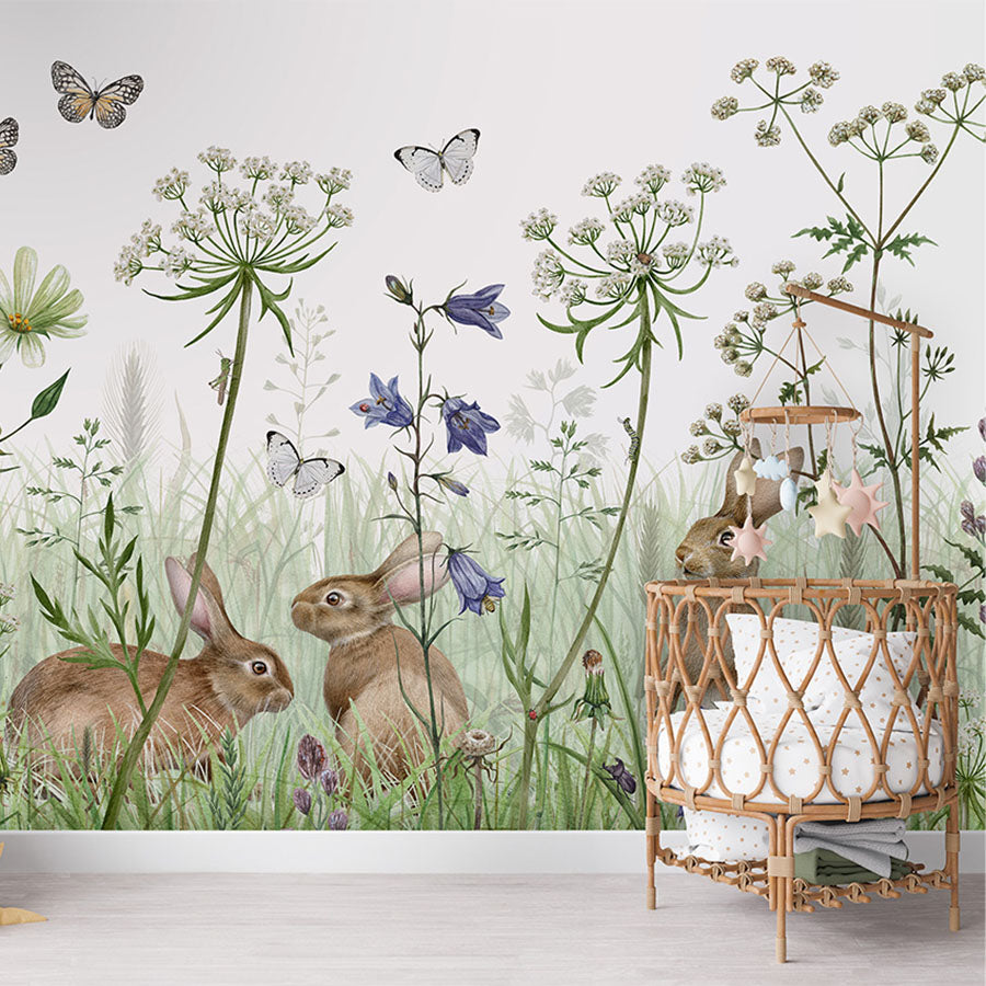In the Undergrowth wallpaper mural in a nursery rattan cot