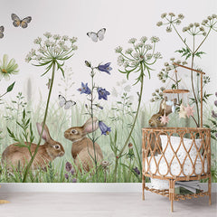 In the Undergrowth wallpaper mural in a nursery rattan cot