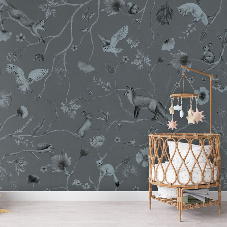 Playful Forest – Monochrome Blue wallpaper mural in a rattan crib