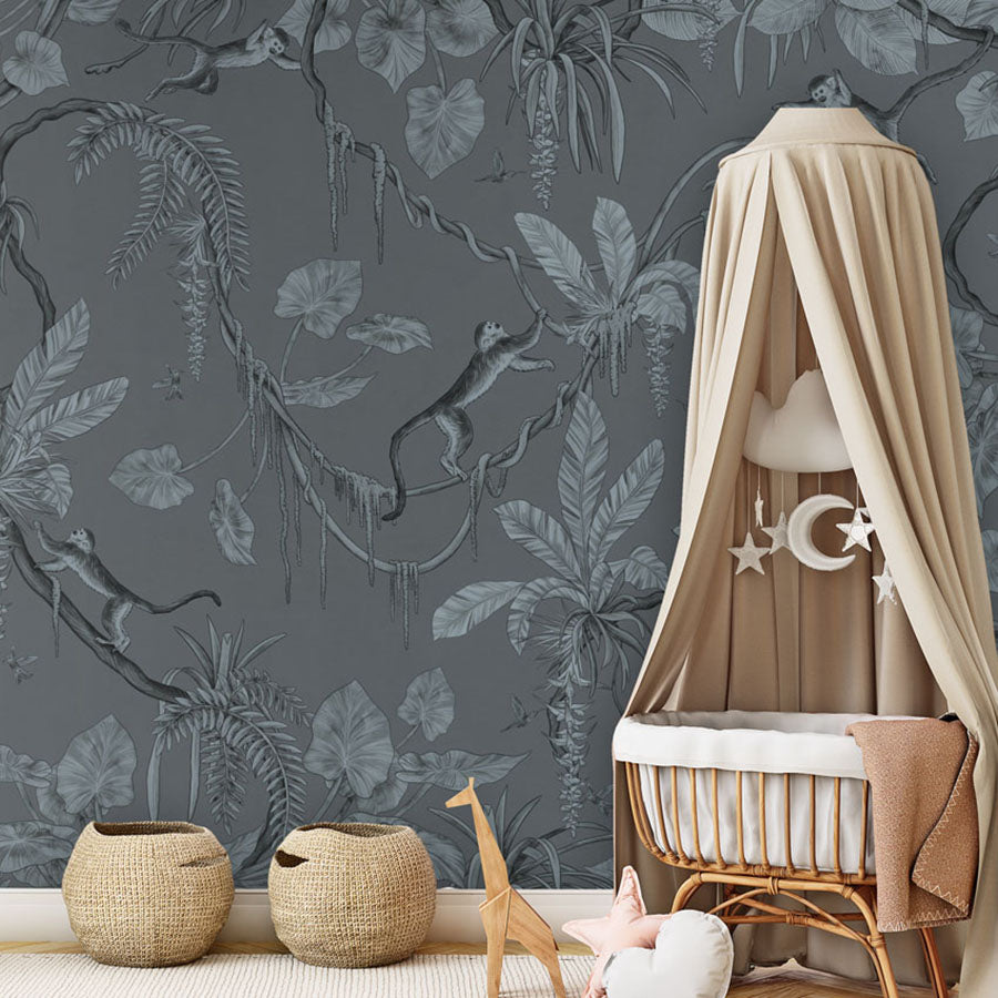 Playful Monkeys – Monochrome Blue wallpaper mural in a nursery rattan cot canopy