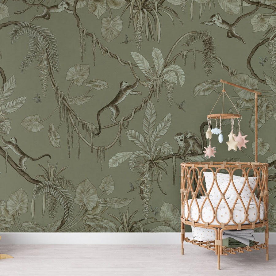 Playful Monkeys – Monochrome Green wallpaper mural in a nursery rattan cot