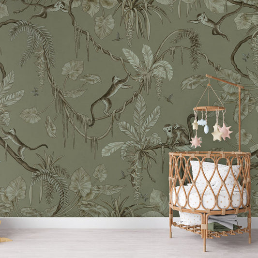 Playful Monkeys – Monochrome Green wallpaper mural in a nursery rattan cot