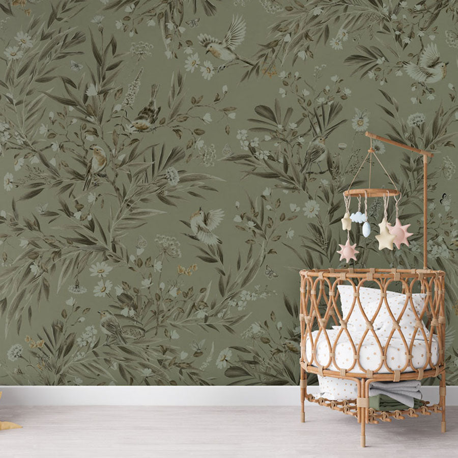 Playful Robins – Monochrome Green wallpaper mural in a nursery rattan cot