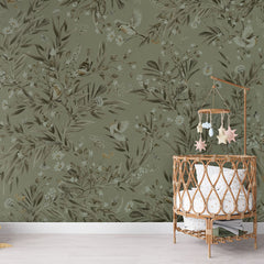 Playful Robins – Monochrome Green wallpaper mural in a nursery rattan cot