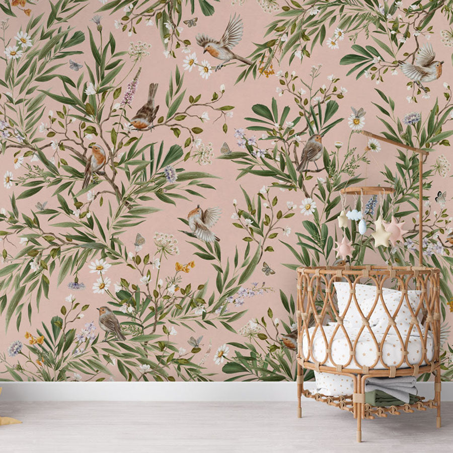 Playful Robins – Pink wallpaper mural in a nursery rattan cot