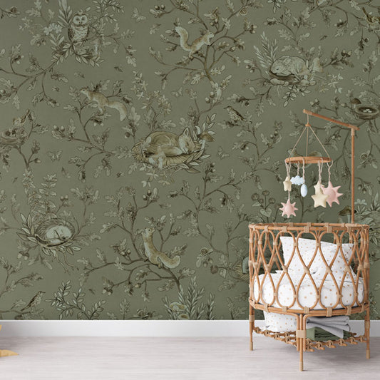 Playful Woods – Monochrome Green wallpaper mural in a nursery rattan cot