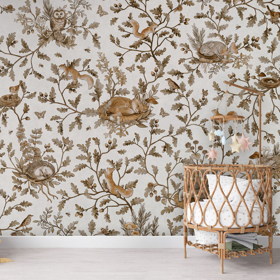 Playful Woods – Vintage White wallpaper mural in a nursery rattan cot