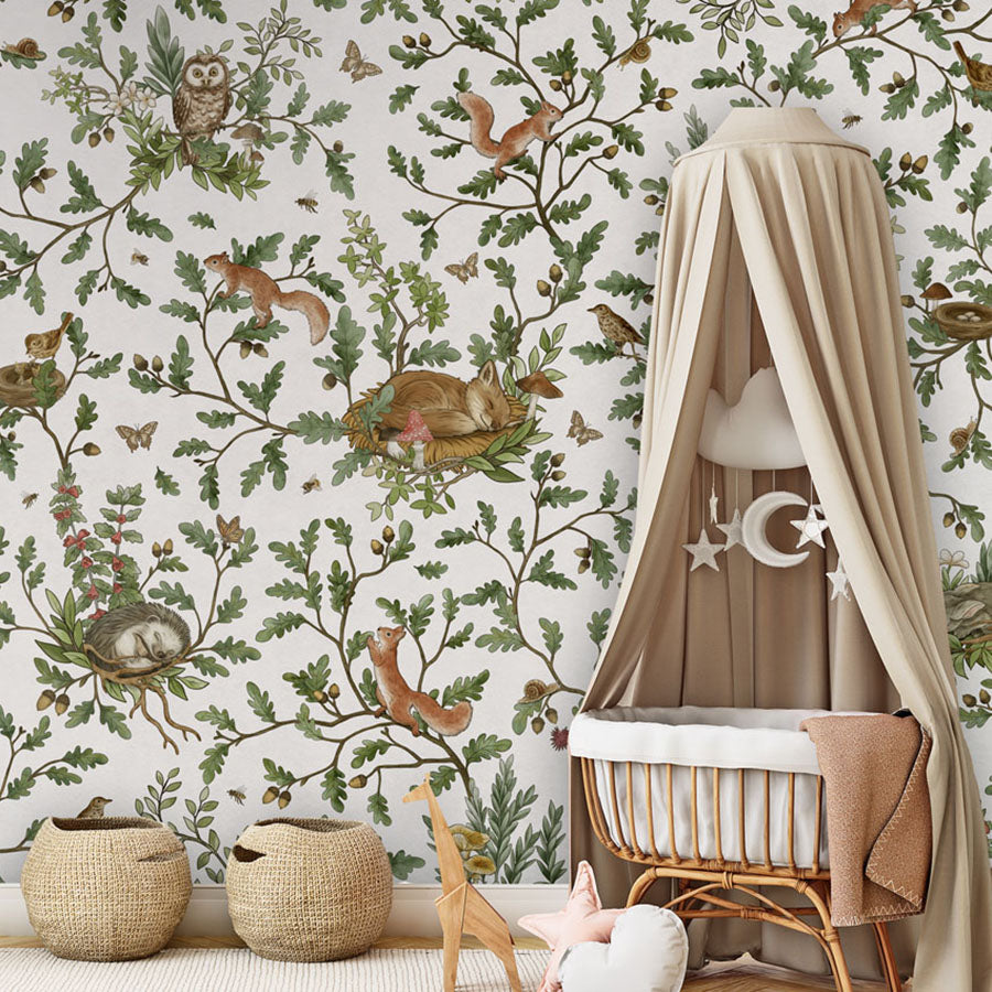 Playful Woods – White wallpaper mural in a nursery rattan cot canopy