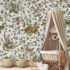 Playful Woods – White wallpaper mural in a nursery rattan cot canopy