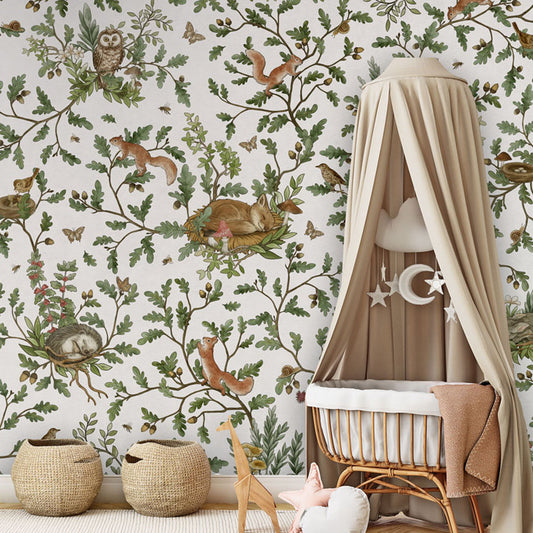 Playful Woods – White wallpaper mural in a nursery rattan cot canopy