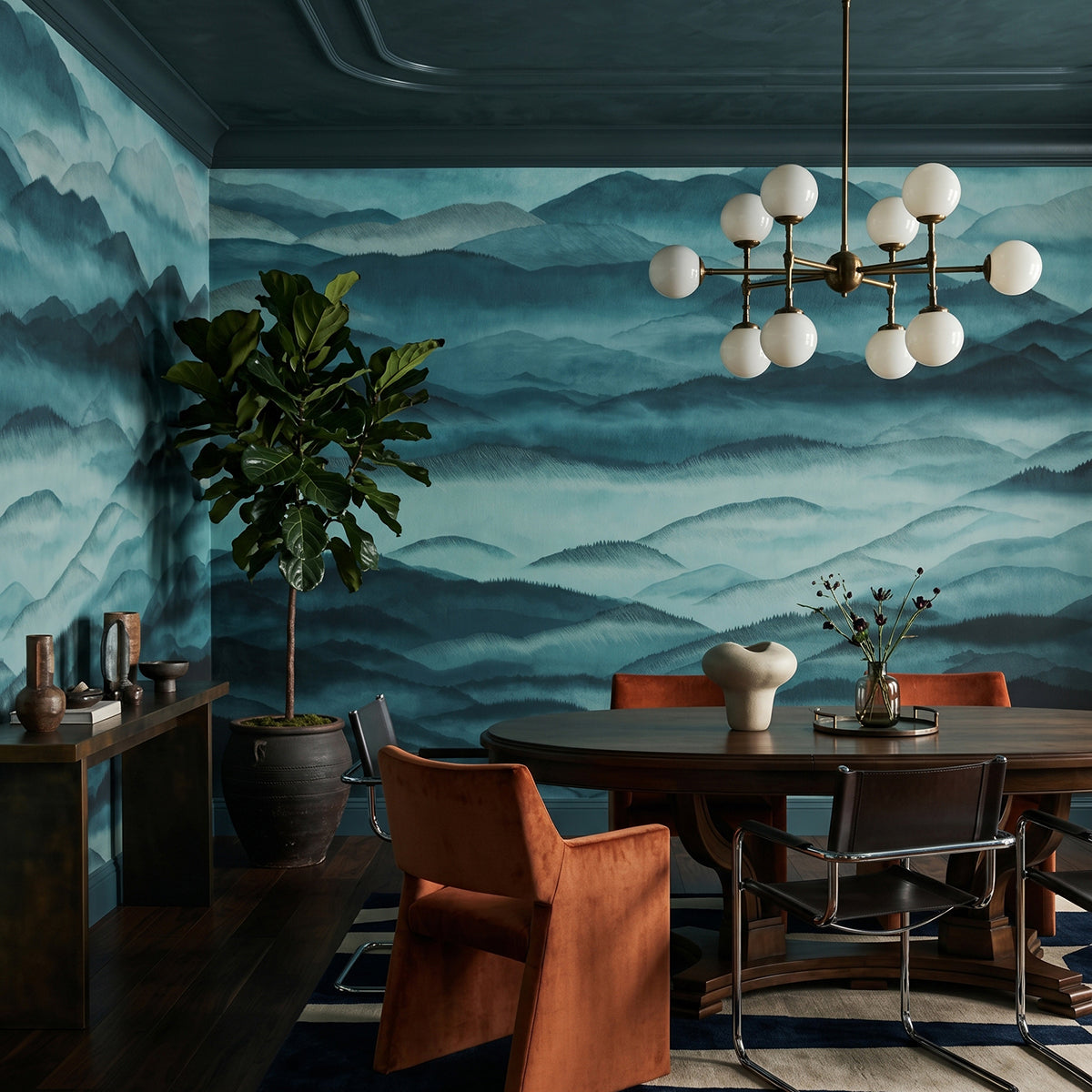 Roerich Hills wallpaper mural shown in dining room with table and orange chairs