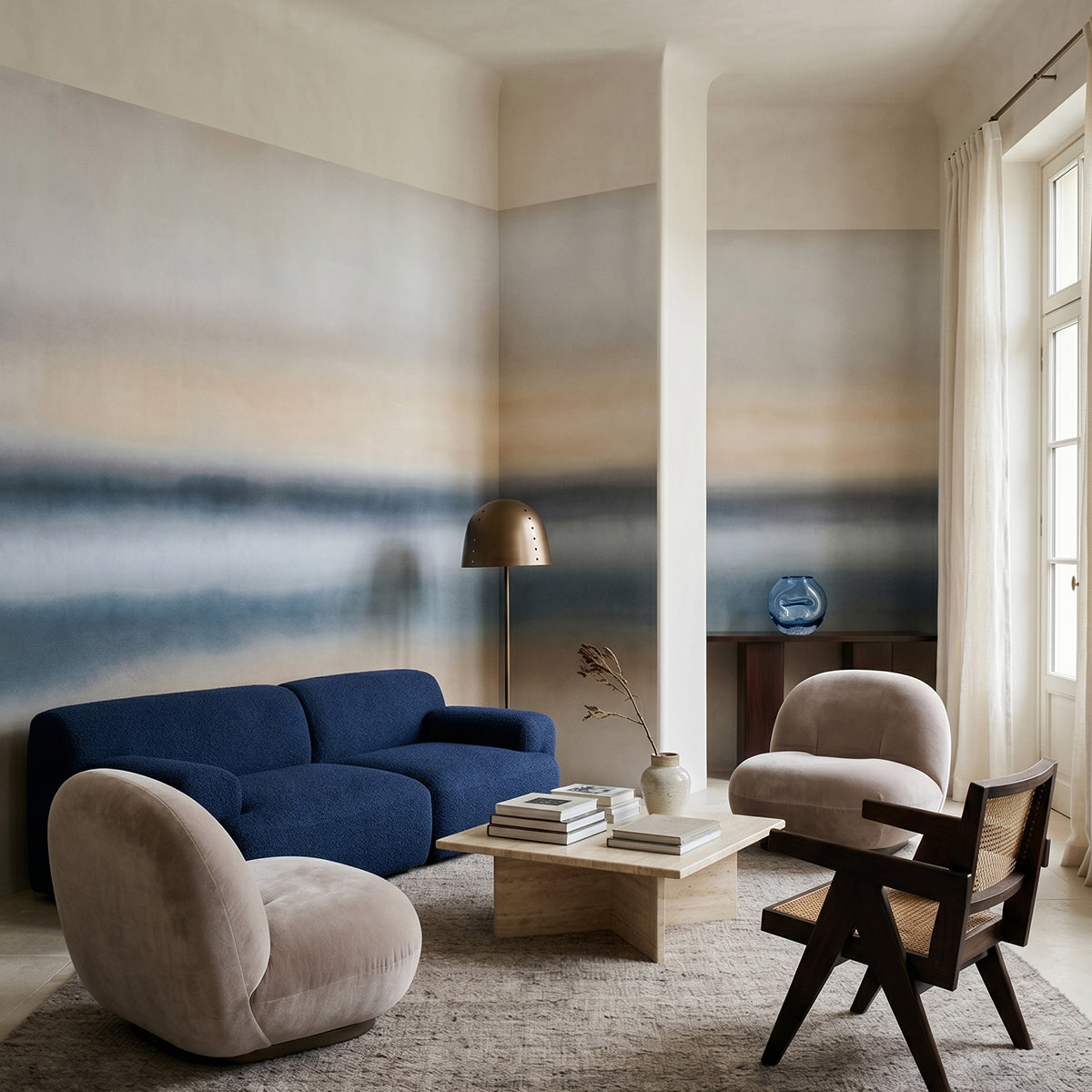 Rotko Ash wallpaper mural shown in living room with blue sofa and white armchair