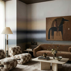 Rotko Ash wallpaper mural shown in living room with brown sofa and patterned armchairs