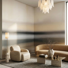 Rotko Ash wallpaper mural shown in living room with brown sofa and white armchair