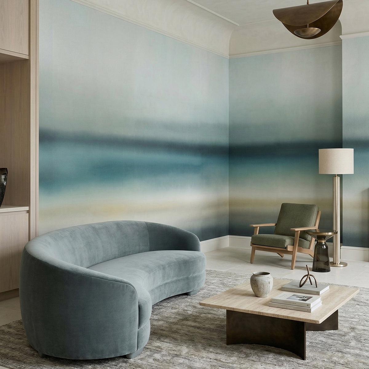 Rotko Blush wallpaper mural shown in living room with blue curved sofa and wood chair
