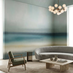 Rotko Blush wallpaper mural shown in living room with grey curved sofa and green chair