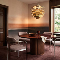 Rotko Dawn wallpaper mural shown in dining room with round table and pink chairs