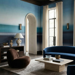 Rotko Veil wallpaper mural shown in living room with blue sofa and brown armchair