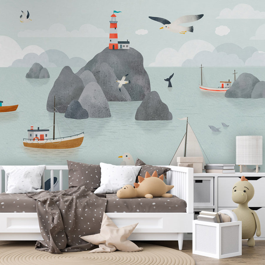 Seaside Stories wallpaper mural shown in a children's bedroom sofa