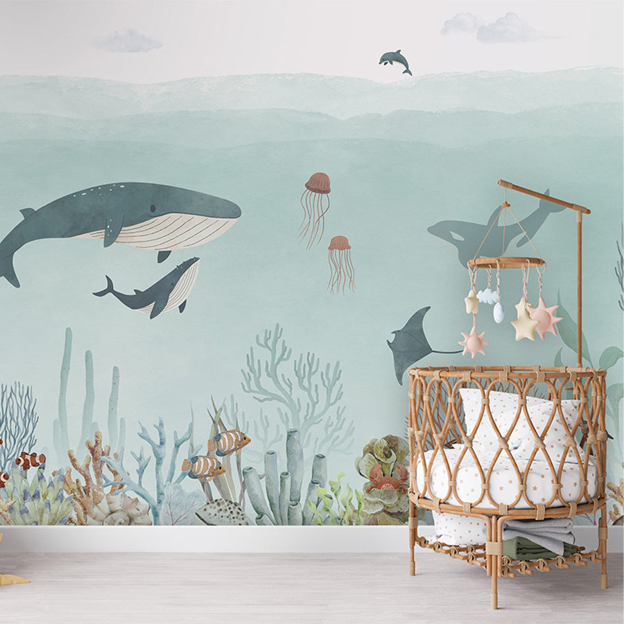 Sensational Sea – Blue wallpaper mural shown in a children's nursery crib