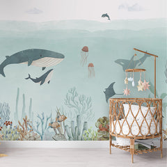 Sensational Sea – Blue wallpaper mural shown in a children's nursery crib