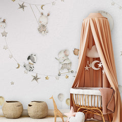 Sleeping Moon wallpaper mural shown in a children's nursery canopy crib