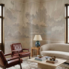 Velvet Smoke wallpaper mural shown in living room with curved sofa and leather armchairs