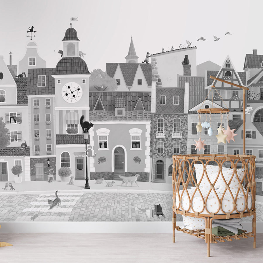 Village Cats – Black and White wallpaper mural shown in a children's nursery crib